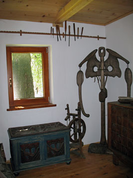 image of a wooden sculpture known as Skeleton and a decorative linen chest made of wood